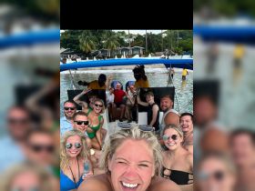 A lively group enjoys a fun day on the boat, capturing joyful moments and celebrations in a picturesque setting.