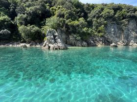 A stunning view of a rocky coastline with crystal-clear waters, perfect for exploring and enjoying the natural beauty of the area.