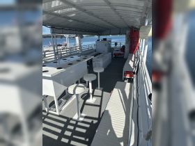 Interior view of a spacious boat cabin featuring seating and amenities, perfect for comfortable outings on the water.