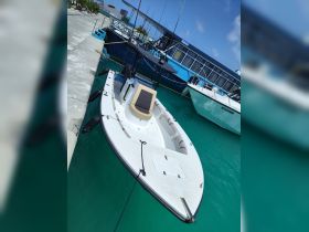 A sleek speedboat docked at a marina, showcasing its clean lines and inviting design — perfect for a day on the water.