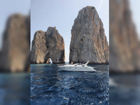 A stunning view of a boat navigating through the iconic rock formations of Cabo San Lucas, showcasing the beauty of the ocean and the unique landscape.