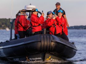 A lively group enjoys a fun outing on a RIB boat, capturing memories with smiles and excitement — perfect for adventure seekers in Stockholm.