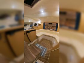 Interior view of a cozy boat cabin featuring comfortable seating and essential amenities, perfect for relaxing during a day on the water.