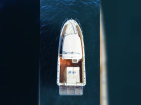 Aerial view of a sleek boat showcasing its elegant design and spacious deck, perfect for leisurely outings on the water.