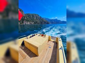 A beautifully arranged seating area on a boat deck, featuring refreshments and snacks, perfect for enjoying the scenic views while cruising.
