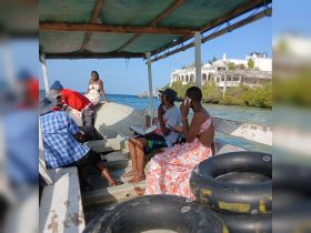 A lively group enjoys a boat ride with stunning ocean views, perfect for exploring nearby islands and creating unforgettable memories.