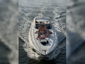 A lively group enjoys a fun day on a yacht, celebrating with drinks and laughter on the water — perfect for summer outings and memorable gatherings.