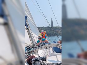 A joyful family enjoys a sailing adventure with a scenic landmark in the background, capturing the essence of fun and exploration on the water.