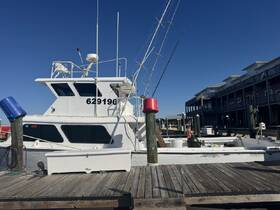 A fishing boat docked at the marina, showcasing its structure and details against a clear blue sky. Perfect for fishing enthusiasts and charter services.