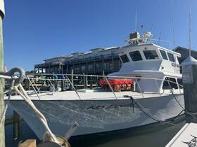 A well-maintained fishing boat named 'No Doubt' docked at the marina, showcasing its sturdy design against a clear blue sky.
