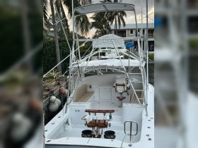 Interior view of a well-equipped boat featuring comfortable seating and a helm area, perfect for fishing or leisurely cruises.
