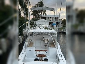 A well-equipped helm area of a boat featuring comfortable seating and essential controls, perfect for a day on the water.