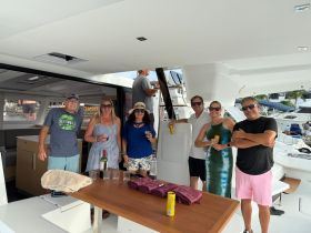 A lively group enjoys drinks aboard a stylish boat, perfect for celebrations and social gatherings on the water.