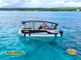 A sleek pontoon boat glides through crystal-clear waters, showcasing the perfect vessel for leisurely outings with friends and family.