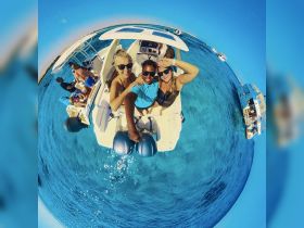 A joyful group poses for a selfie on a boat in crystal-clear waters, capturing the essence of fun and adventure on the water.