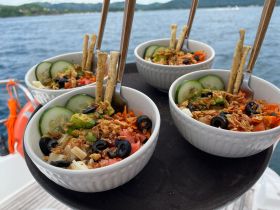 A beautifully arranged selection of fresh salads served on a boat, perfect for enjoying a healthy snack while cruising on the water.
