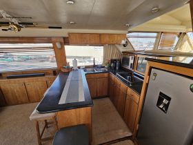 Interior view of a well-equipped boat kitchen, featuring modern appliances and ample counter space, perfect for preparing meals while on the water.