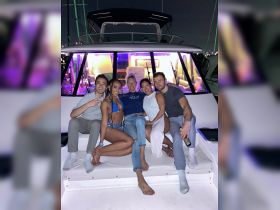 A lively group of friends enjoys a night out on a boat, celebrating together in style. The vibrant atmosphere and camaraderie make for an unforgettable boat party experience.