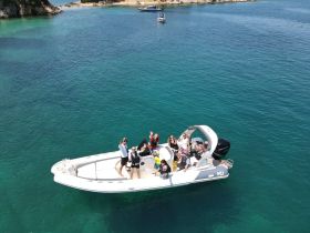 A lively group enjoys a day out on the water aboard a boat, perfect for celebrations and fun gatherings in beautiful surroundings.