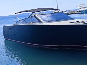 A sleek Colnago 35 boat docked in clear waters, showcasing its modern design and elegance — perfect for luxury outings on the water.