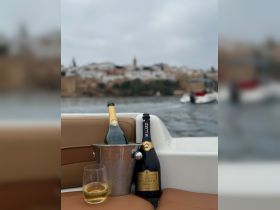 A stylish display of champagne and drinks on a boat, perfect for celebrating special moments while enjoying the scenic views.