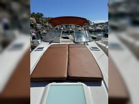 A cozy lounge area on a boat featuring plush seating, perfect for relaxing while enjoying the marina views.
