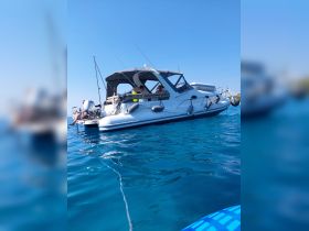 A group of friends enjoys a relaxing day on a boat, surrounded by crystal-clear waters — perfect for summer outings and adventures.