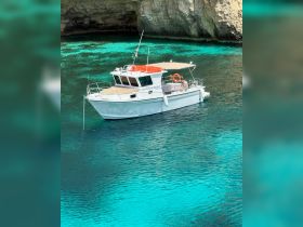 A scenic view of a boat anchored in crystal-clear turquoise waters, perfect for exploring coastal destinations or enjoying a day on the water.