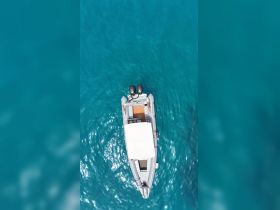 Aerial view of a sleek speedboat gliding through crystal-clear turquoise waters, perfect for exploring coastal destinations.
