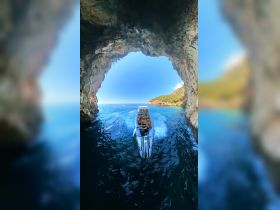 A group of friends enjoys an adventurous boat ride through a stunning cave, showcasing the thrill of exploration on the water.