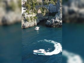 A scenic view of a boat navigating through the stunning coastline, showcasing the beauty of the landscape and the thrill of boating adventures.