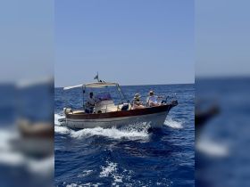 A lively scene of a boat cruising through the ocean with guests enjoying the ride — perfect for adventure seekers and ocean lovers.