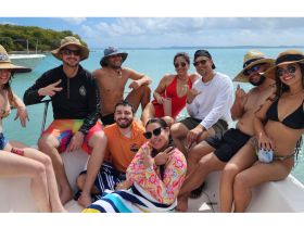 A lively group enjoys a fun day on the water, showcasing camaraderie and celebration aboard a boat — perfect for summer outings and memorable adventures.