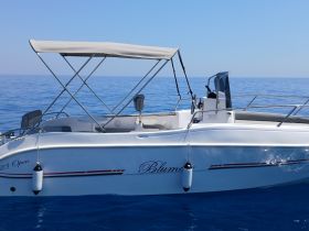 A sleek speedboat named 'Blumo' glides through calm blue waters, showcasing its elegant design and perfect for a day on the sea.