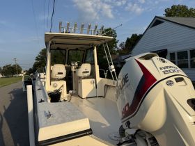 Interior view of a well-equipped boat helm featuring seating and control console, ideal for fishing or leisure outings.