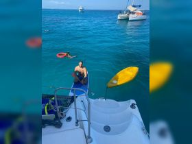 A fun-filled day on the water with paddleboarding, snorkeling, and kayaking, showcasing the vibrant turquoise sea and active enjoyment of the guests.