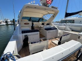 A well-appointed interior view of a boat's cabin featuring comfortable seating and ample storage, perfect for relaxing during a day on the water.