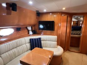 Interior view of a cozy boat cabin featuring comfortable seating and modern amenities, perfect for relaxing during your nautical adventures.