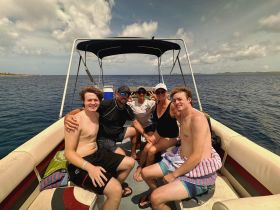 A joyful group of friends enjoys a day on the water, capturing memories aboard their boat. Perfect for family outings or group adventures.
