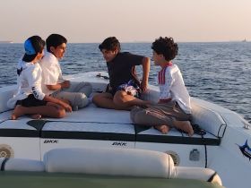 A group of children enjoys a fun moment aboard a boat, creating lasting memories on the water. Perfect for family outings and adventures.
