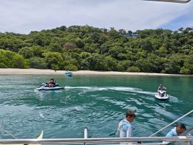 Guests enjoy an exhilarating jet ski ride in clear turquoise waters, with a scenic beach backdrop — perfect for adventure seekers and water sports enthusiasts.