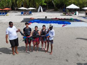 A group prepares for an exciting parasailing adventure on the beach, showcasing the thrill of water sports and fun in the sun.