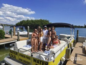 A lively group enjoys a sunny day aboard a water taxi, perfect for mini cruises and fun outings on the water.