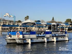 A pontoon boat serving as a water shuttle in St. Augustine, Florida, showcasing a group of guests enjoying the scenic views.