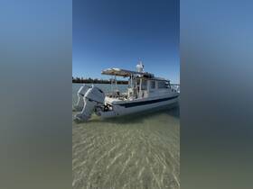 A sleek boat anchored in shallow waters, showcasing its design and structure against a clear blue sky — perfect for water adventures.