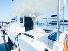 A bright and spacious interior view of a yacht's cabin, showcasing comfortable seating and modern design elements, perfect for relaxing on the water.