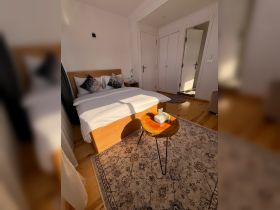 Cozy and modern boat cabin featuring a comfortable bed and stylish decor, perfect for relaxing after a day on the water.