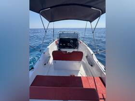 Interior view of a boat's helm and seating area, showcasing a sleek design perfect for navigating the open waters.