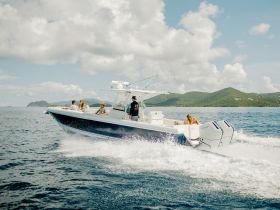 A lively group enjoys a thrilling ride on a speedboat, showcasing the excitement of on-water adventures amidst stunning island scenery.