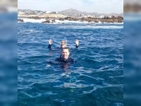 A couple enjoys snorkeling in the vibrant blue waters, showcasing the excitement of underwater exploration and adventure.